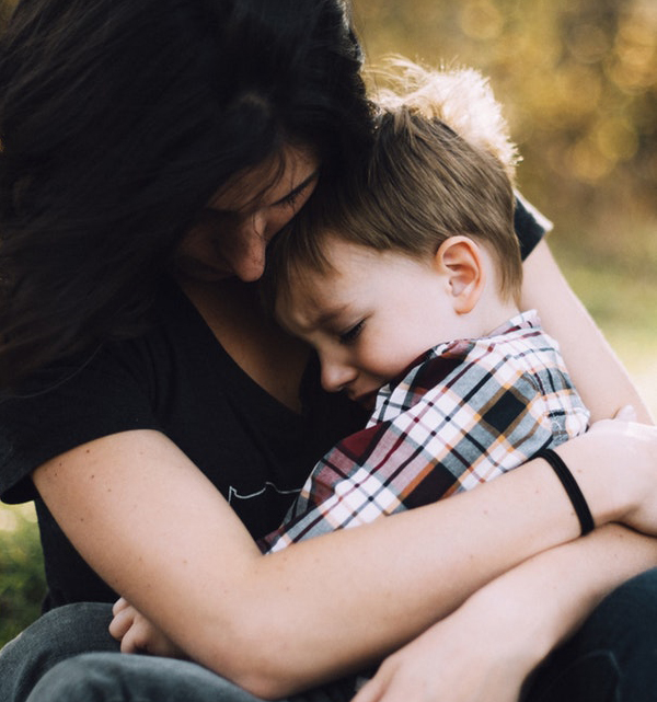 A mother holds her young son