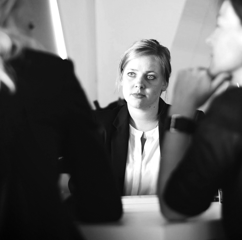 Three women talk seriously with each other
